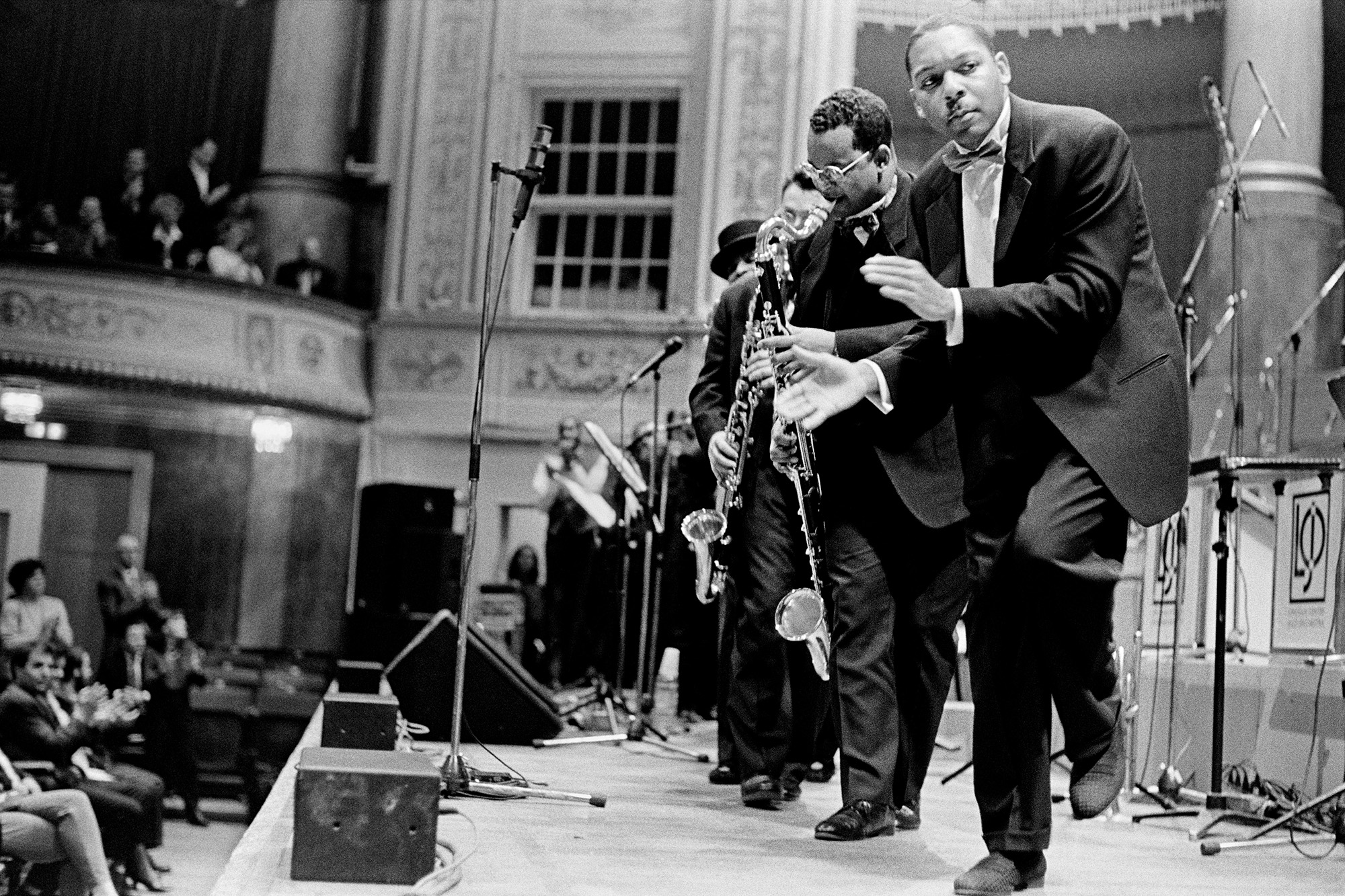 Black and white photo of a black jazz group on stage looking towards the camera on the right