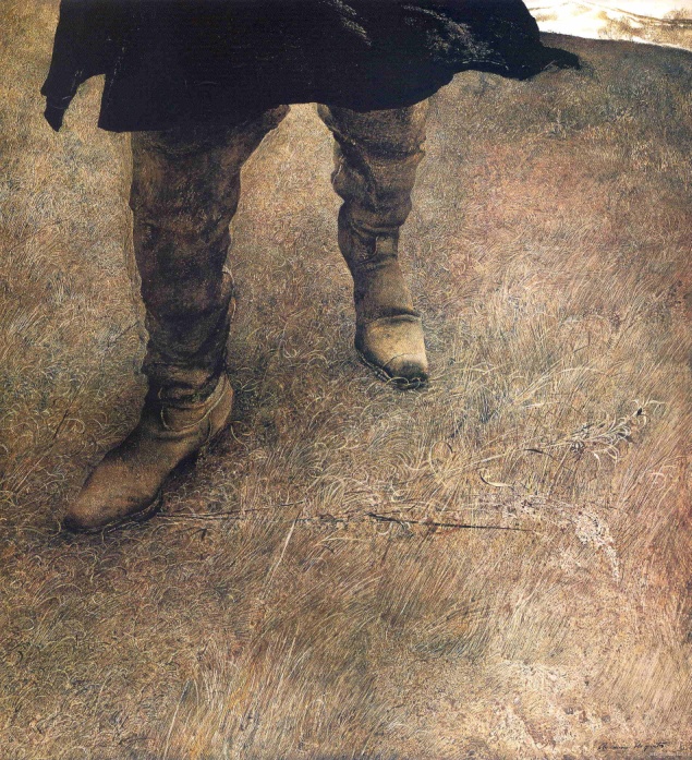 A close up of a person's legs in knee high brown boots amongst a brown background.
