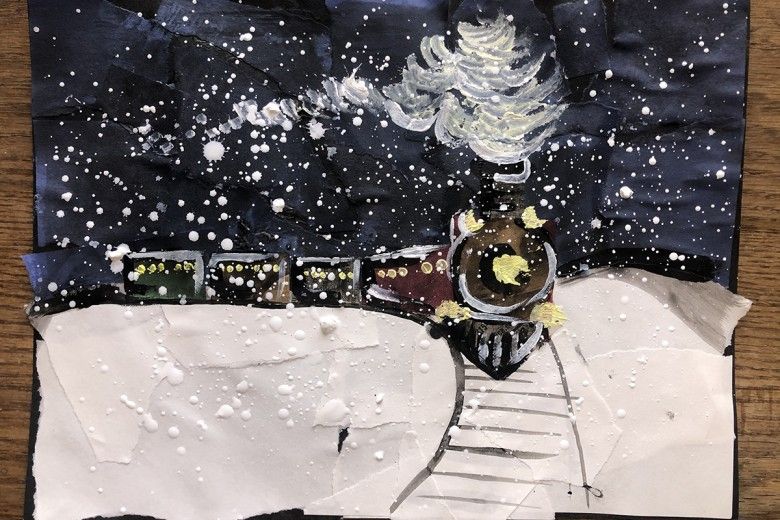 A snowy, nighttime train scene made of construction paper and paint