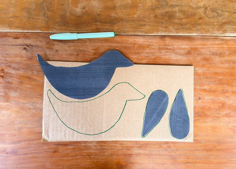 Black bird pattern cut-out and traced onto a piece of cardboard