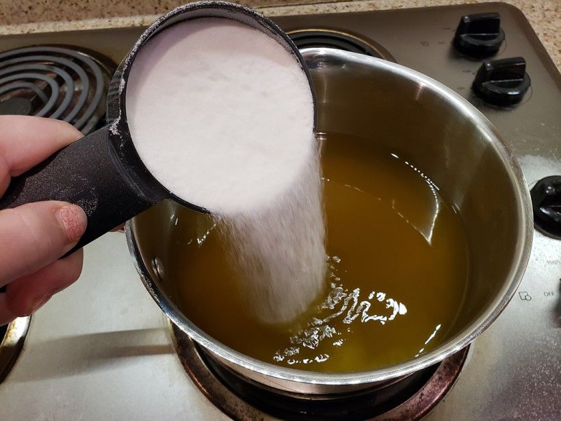Pouring sugar into dandelion water