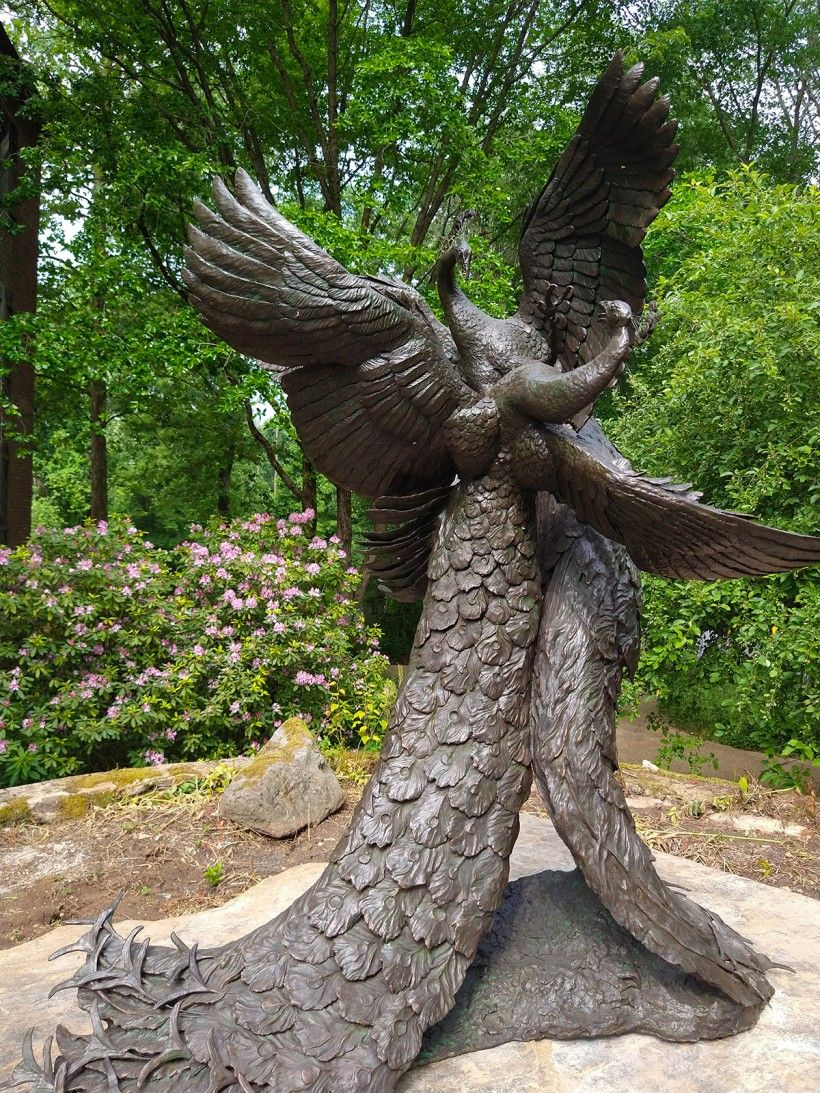 Bronze sculpture of two life-size fighting peacocks in front of the Brandywine's main entrance