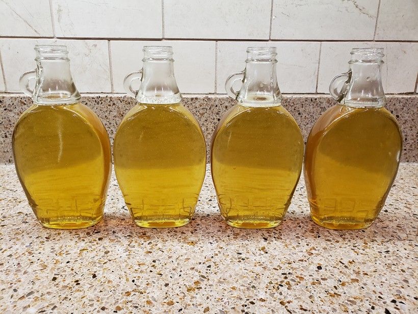 Dandelion simple syrup in glass jars