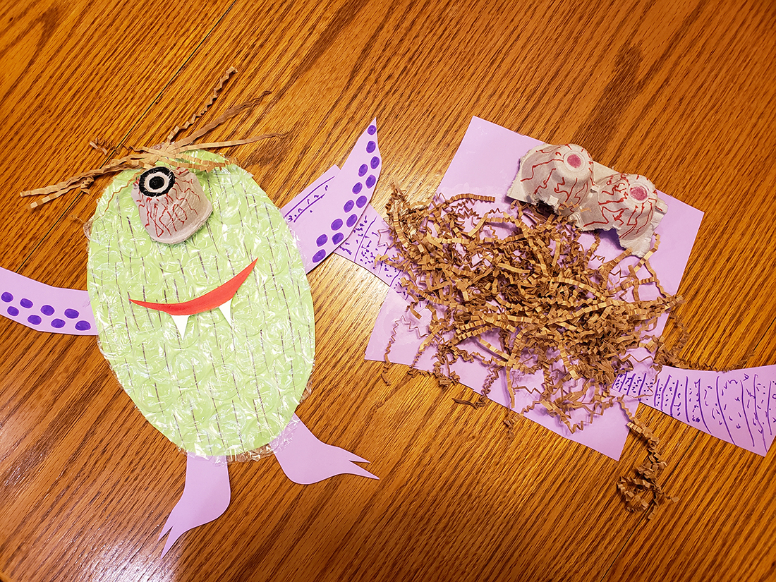 Monster creations made out of paper scraps and other packing materials