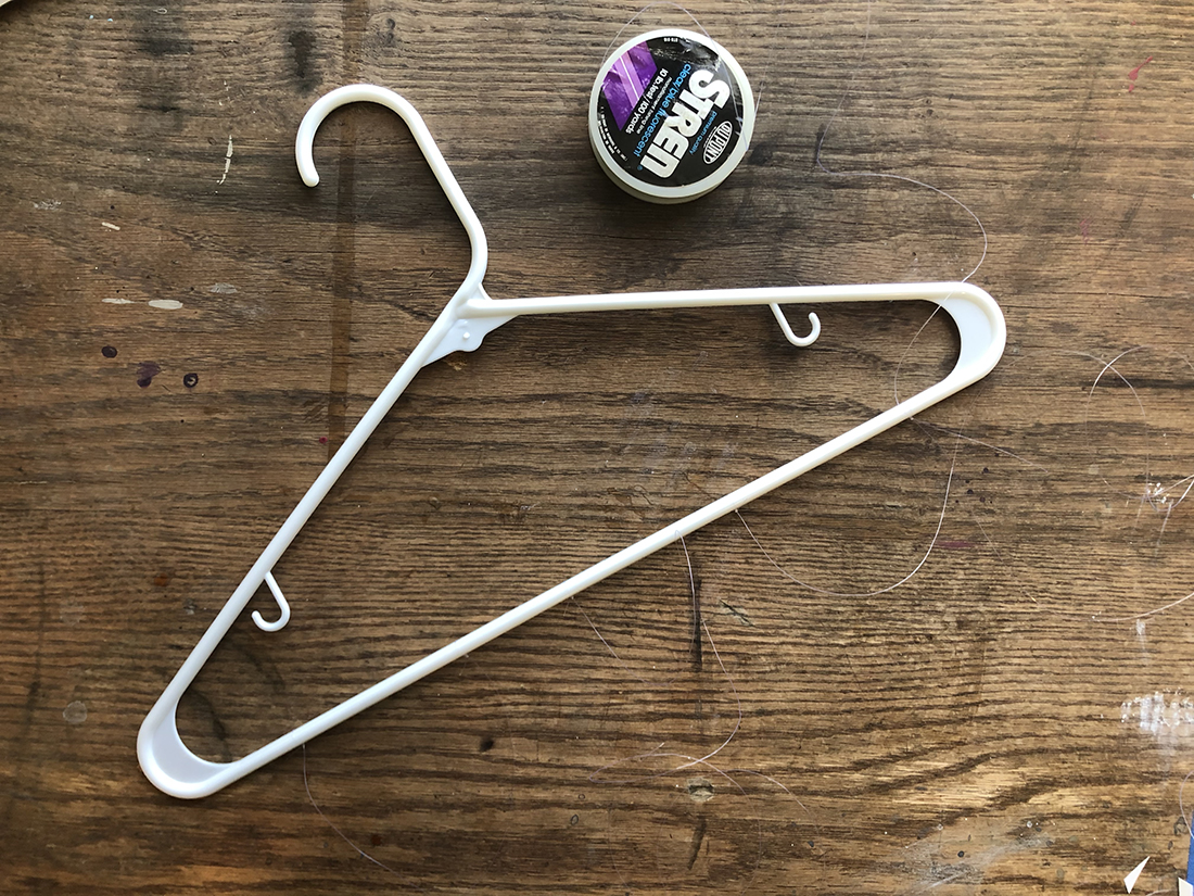 Photo of a white clothes hanger and fishing line