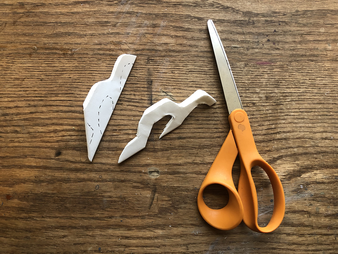 Scissors cutting up snowflake paper