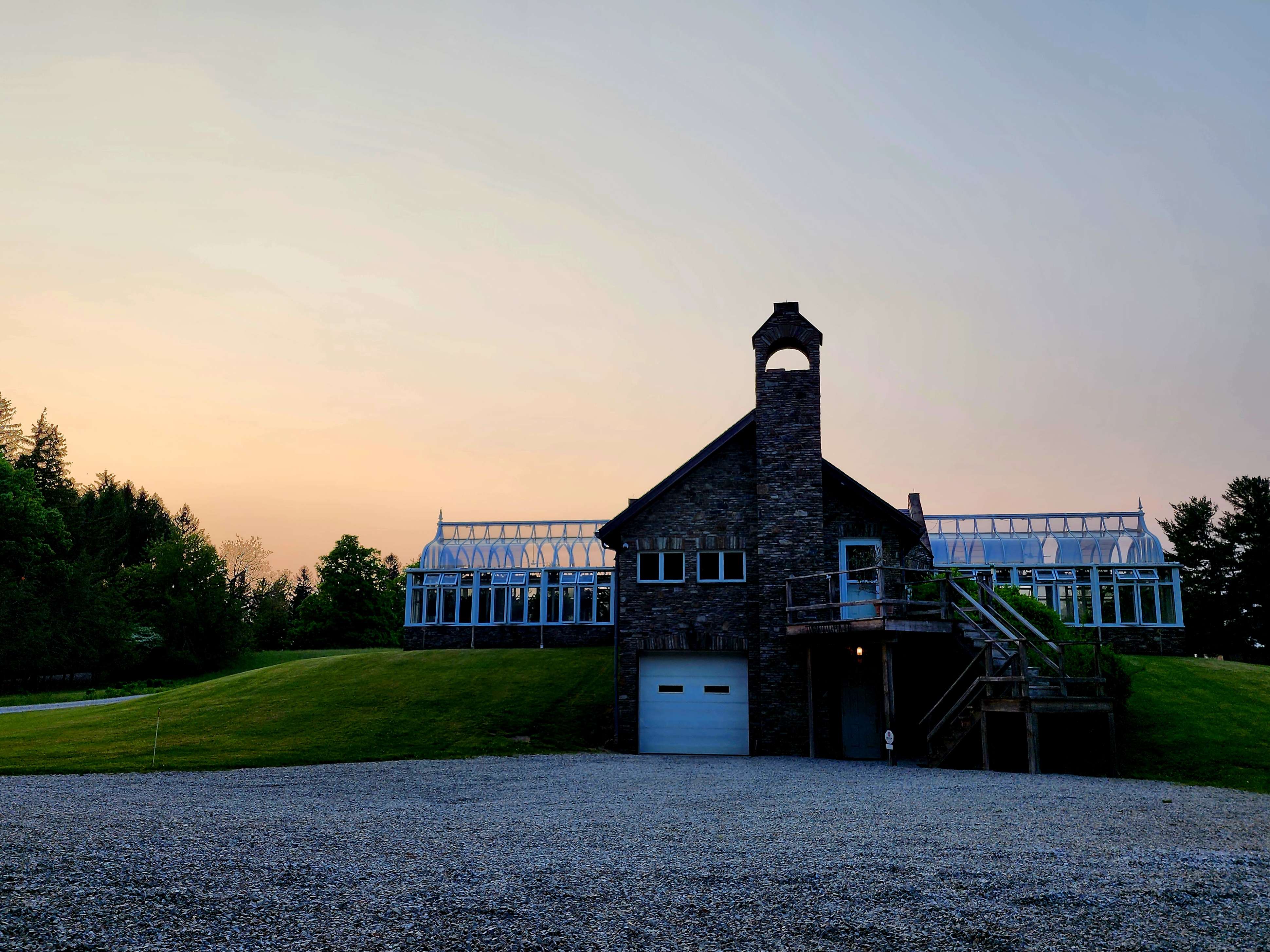 A stone building pictured in the distance at sunset.