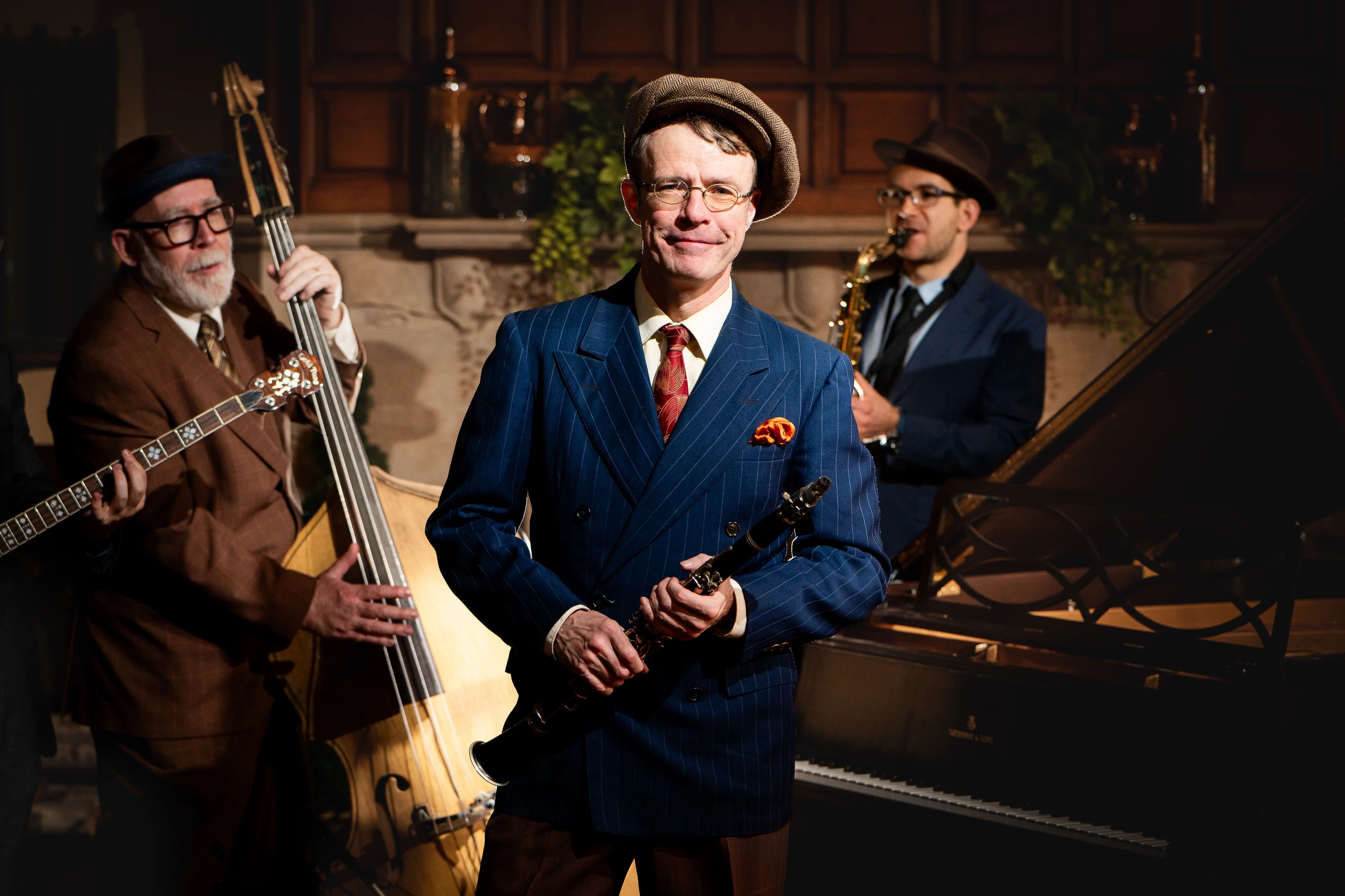 Three musicians stand with their instruments.