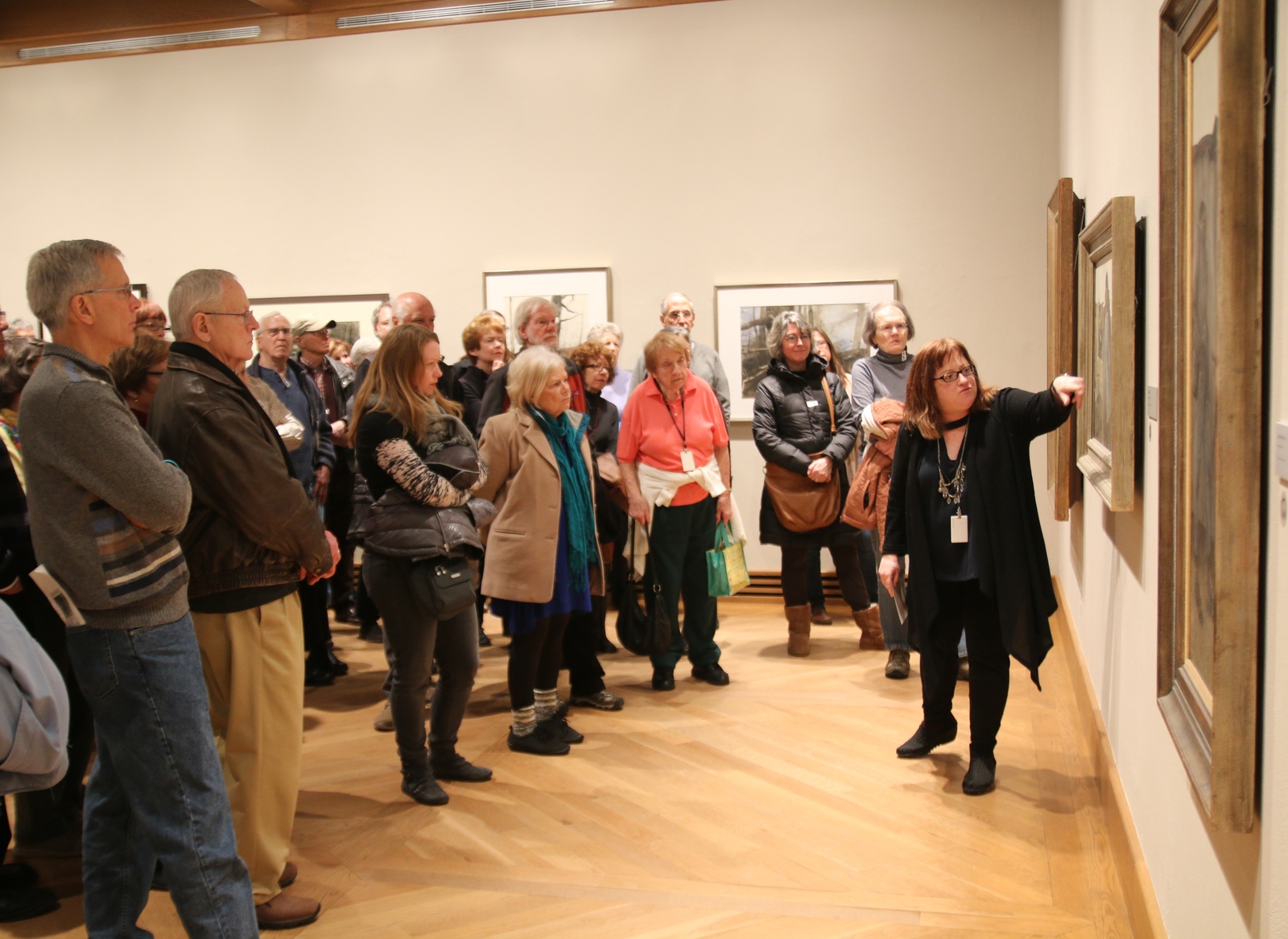 A group of people looking at art in a Museum gallery