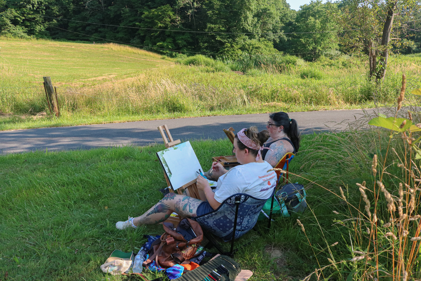 People sitting in chairs, outside, painting at Kuerner Farm