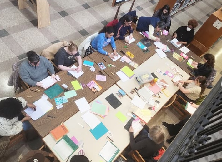 People sitting around a large table making art