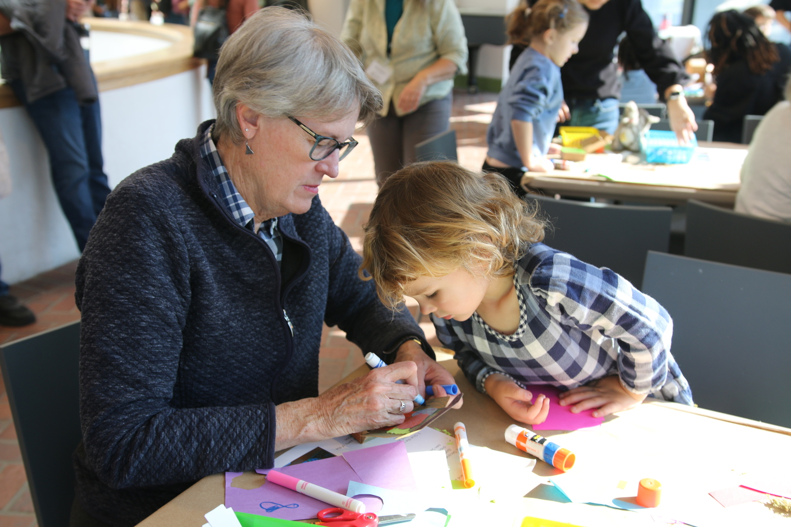 Woman making art with a child