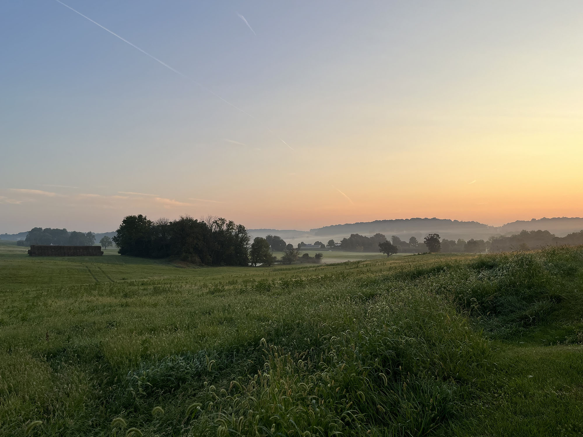 View of a wide open field of protected open space at sunset