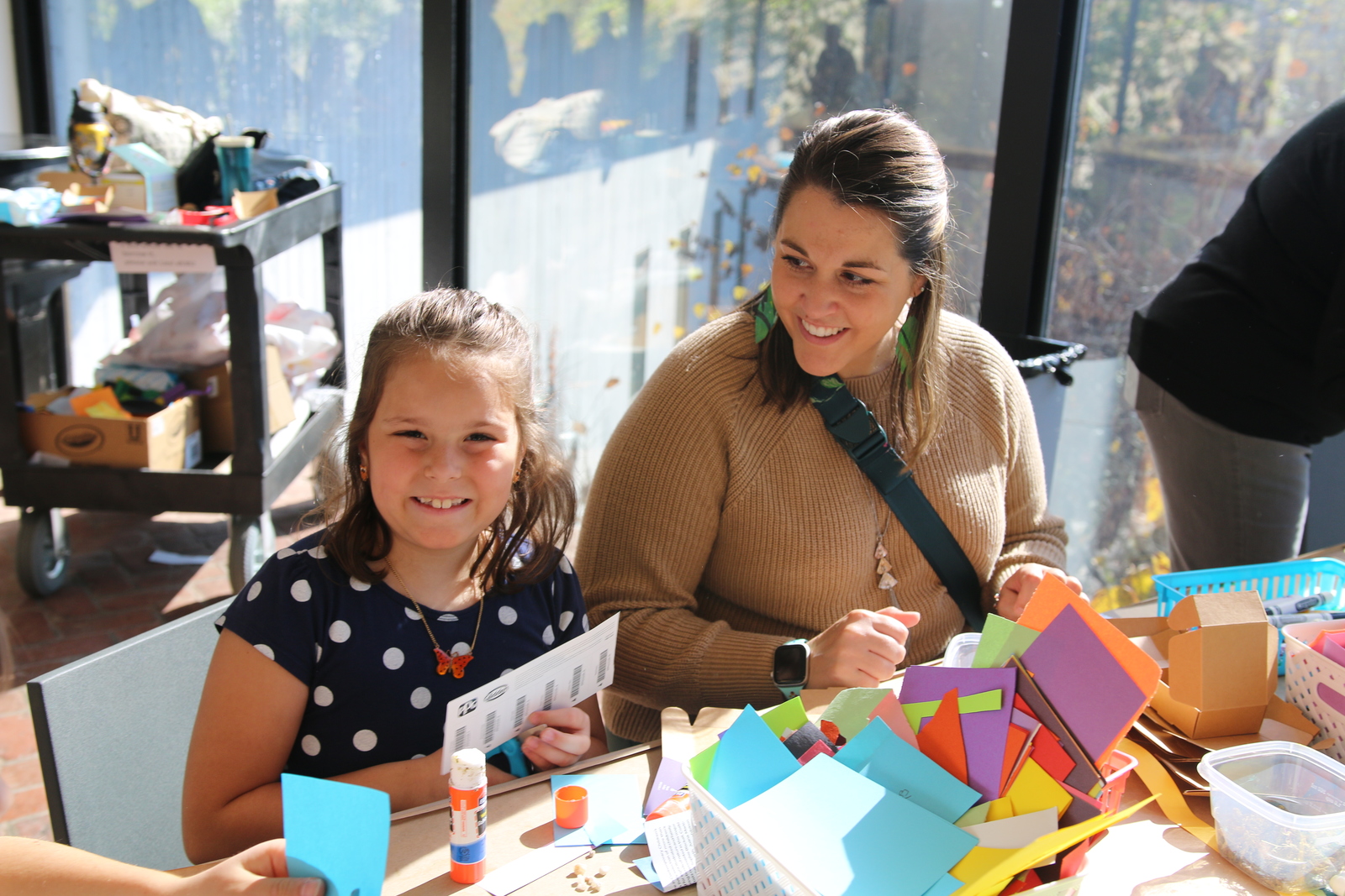 A child making art with their parent