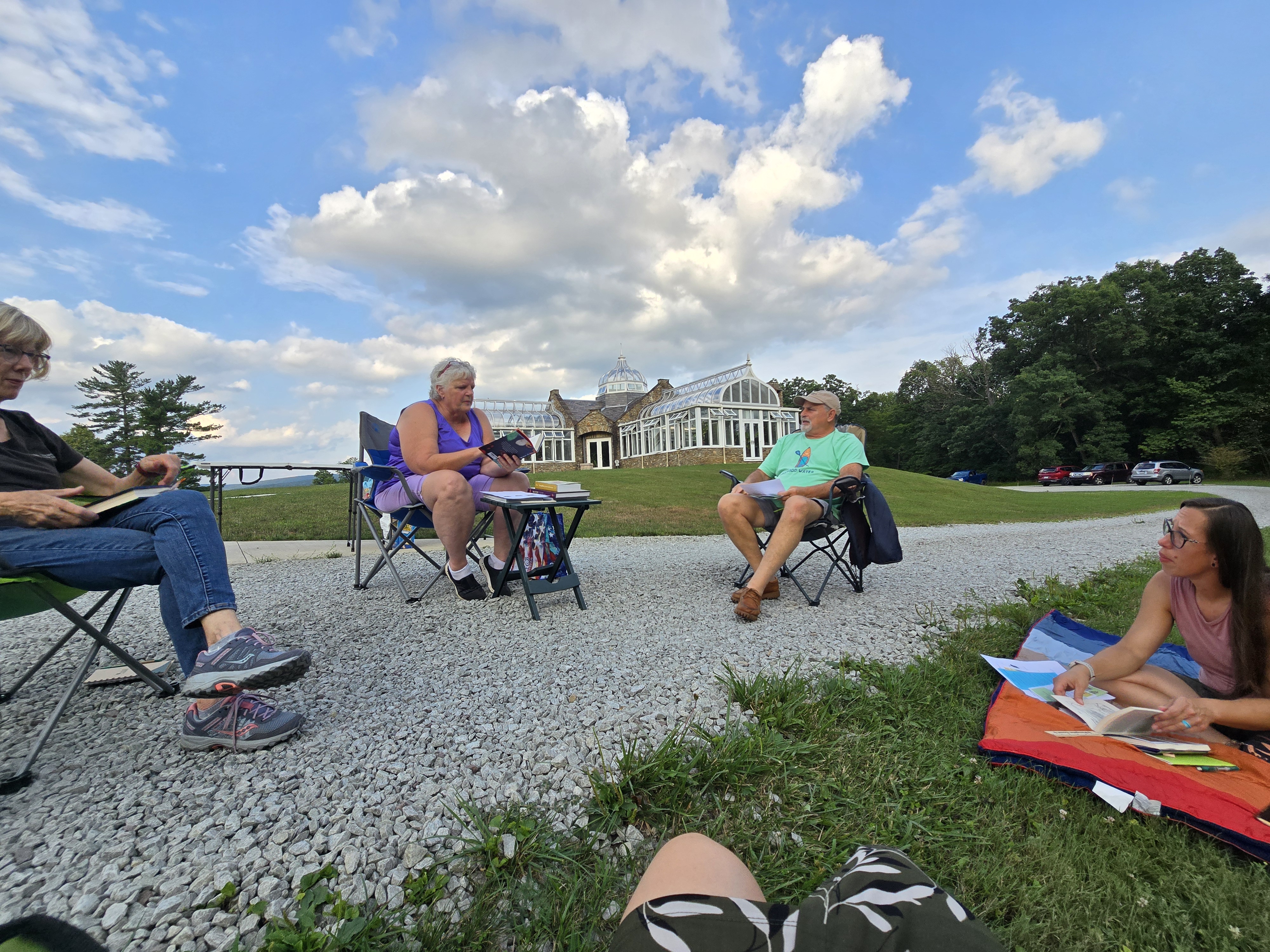 People sitting in a circle reading books