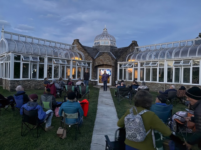 People sitting in chairs at dusk star gazing