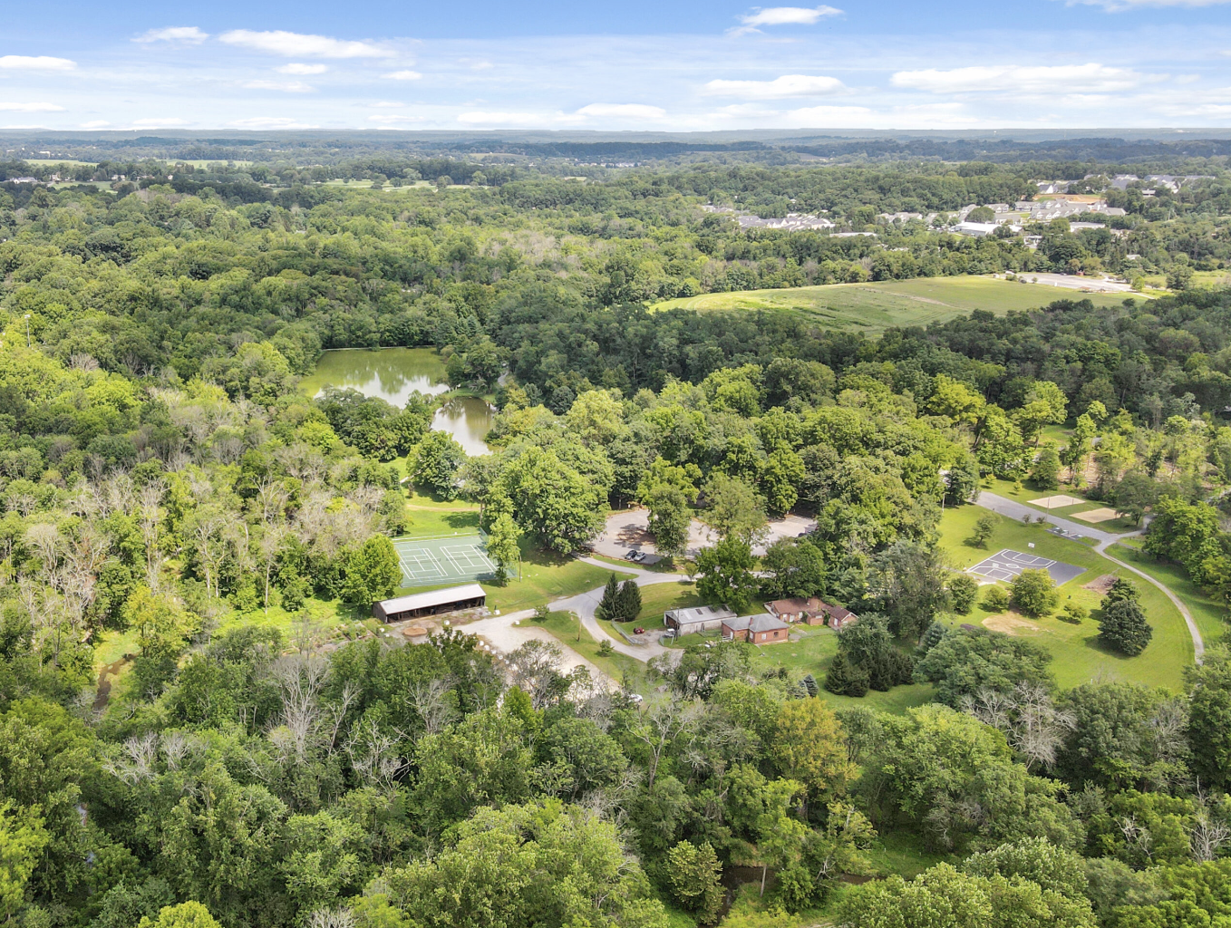 Aerial image of a lush, green park and blue skies.