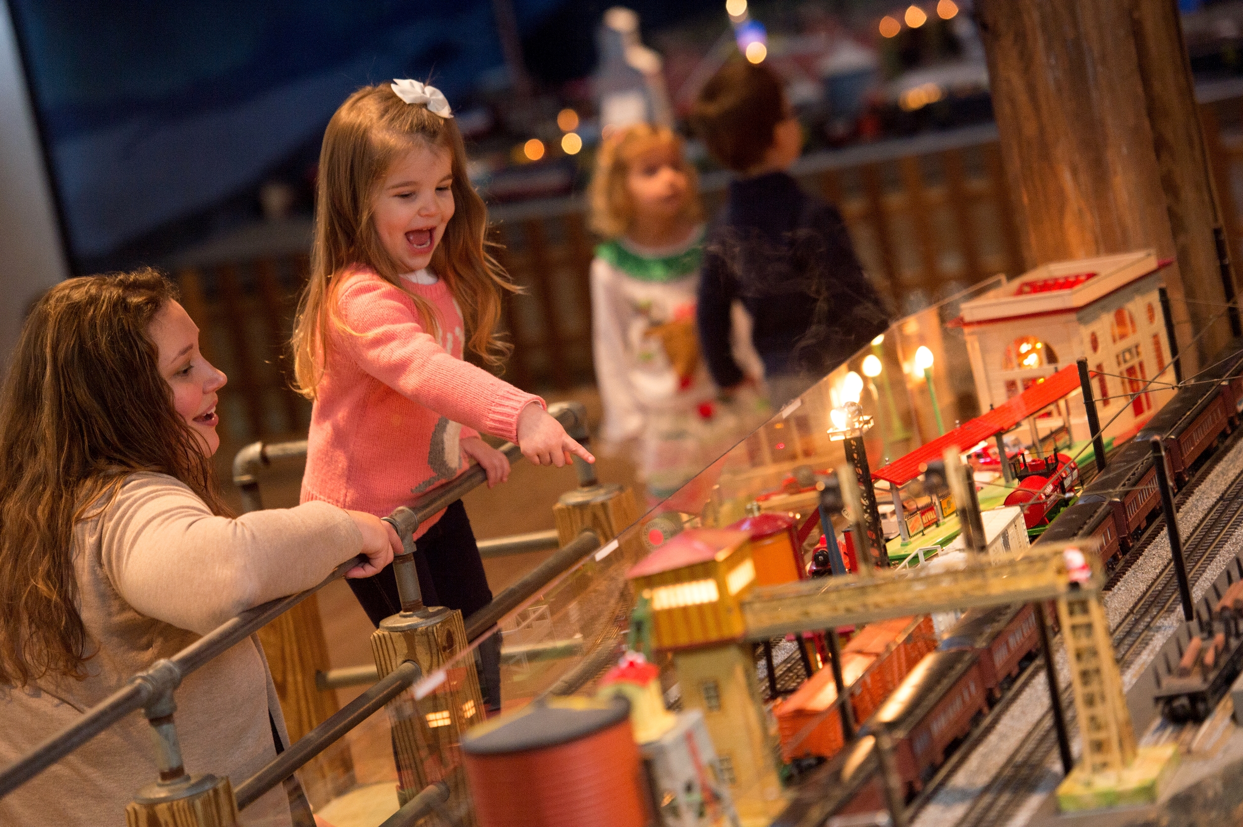 Little girl and family with the Brandywine Christmas train display
