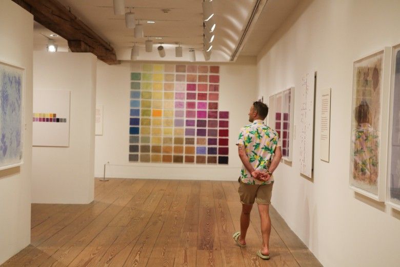 Man looking at art walking through the gallery