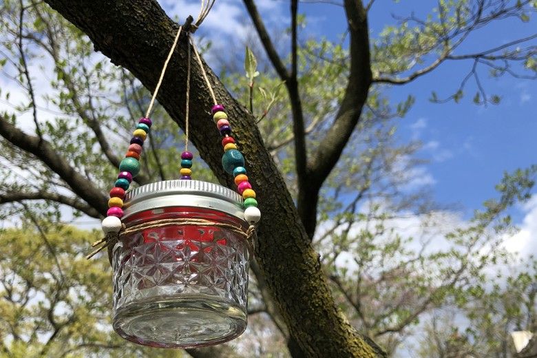 DIY Hummingbird Feeder hanging in a tree
