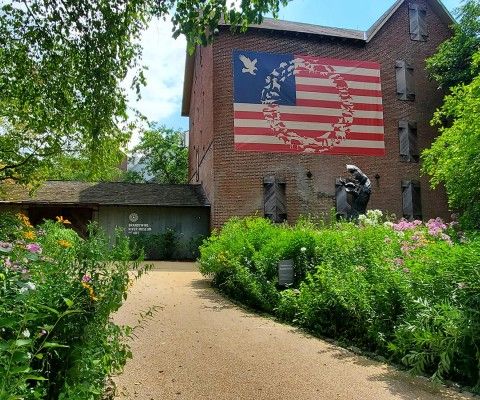 Front entrance of the Museum with a large artwork installed on the mill building.