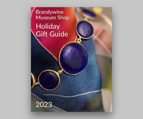 Cover of the gift guide with a colorful scarf and necklace.