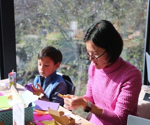 Woman making art with a child