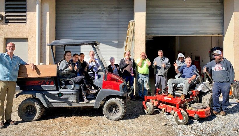 group photo with donated equipment