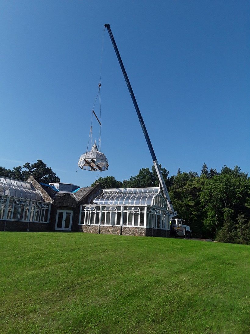Crane removing cupola from Penguin Court's conservatory