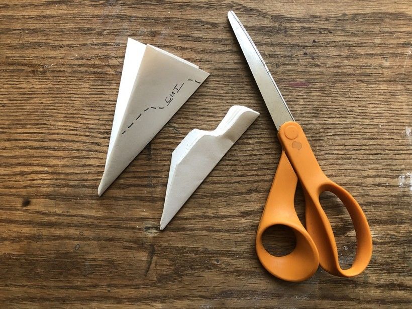 Scissors cutting up snowflake paper