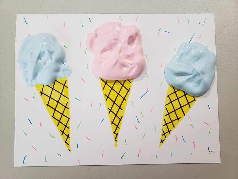 Photo of blue and pink puff paint ice cream cones, before they have finished drying.