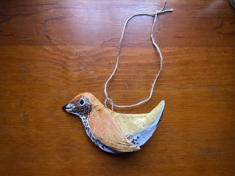 Finished papier-mâché bird with hanging string