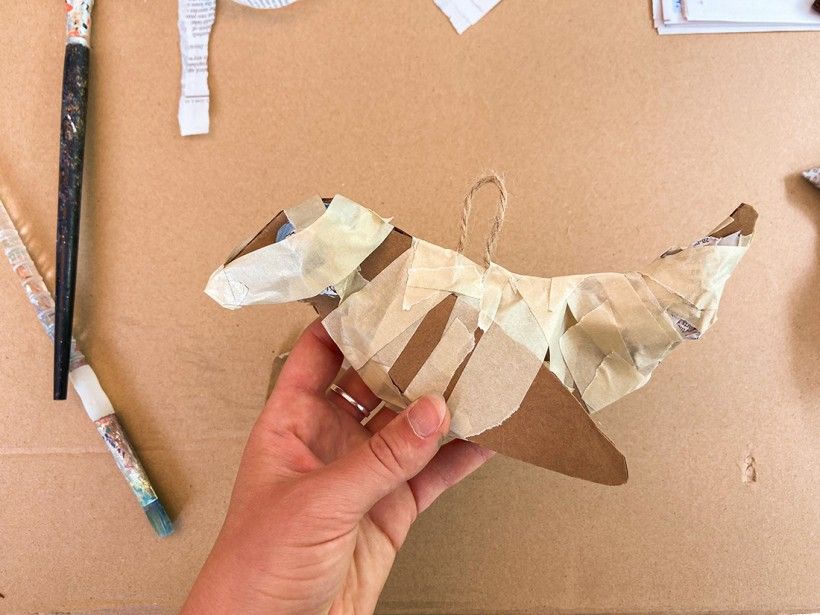 Cardboard cutout of a bird wrapped in masking tape
