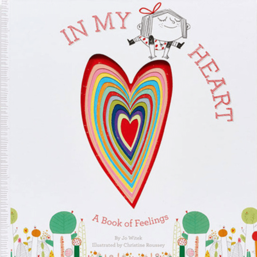 A drawing of a colorful heart with a little girl with a heart patterned dress and a  red ribbon in her hair jumping over the heart, text on the image reads "In My Heart" above the girls head and below the heart reads "A Book of Feelings". 