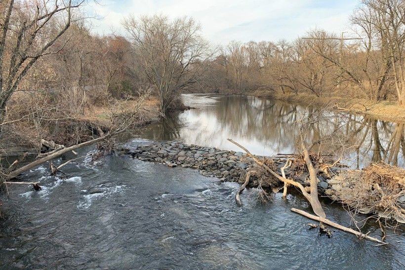 Hoffman's Mill dam as seen from the US Route 1 bridge. Photo credit: Rob Daniels landscape photo of a low head dam seen from a bridge in winter