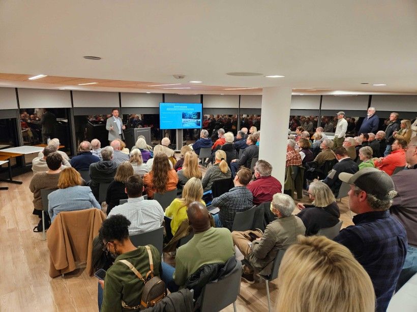 A packed room of seated and standing people attending a meeting in Brandywine's Waterview Room