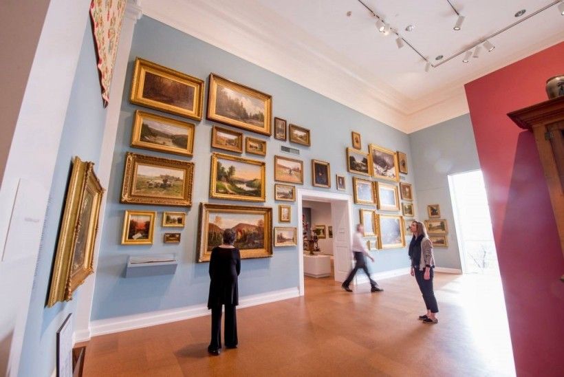 Courtesy of The Westmoreland Museum of Art Museum with framed paintings covering the wall from floor to ceiling