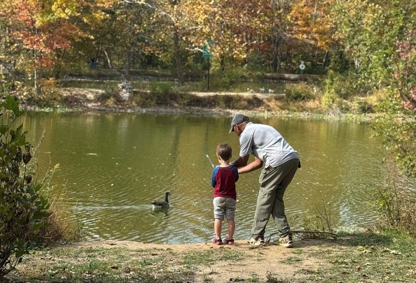 a man teaches a boy to fish