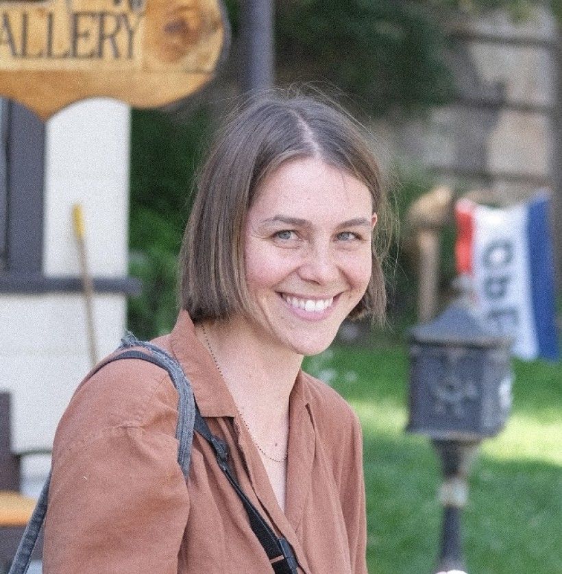 Photo of a woman smiling with short brown hair.