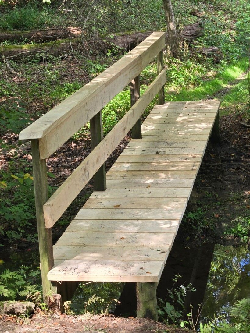 a newly repaired footbridge in Waterloo Mills Preserve