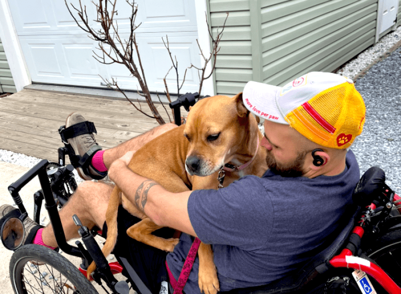 Man holding a dog on his lap