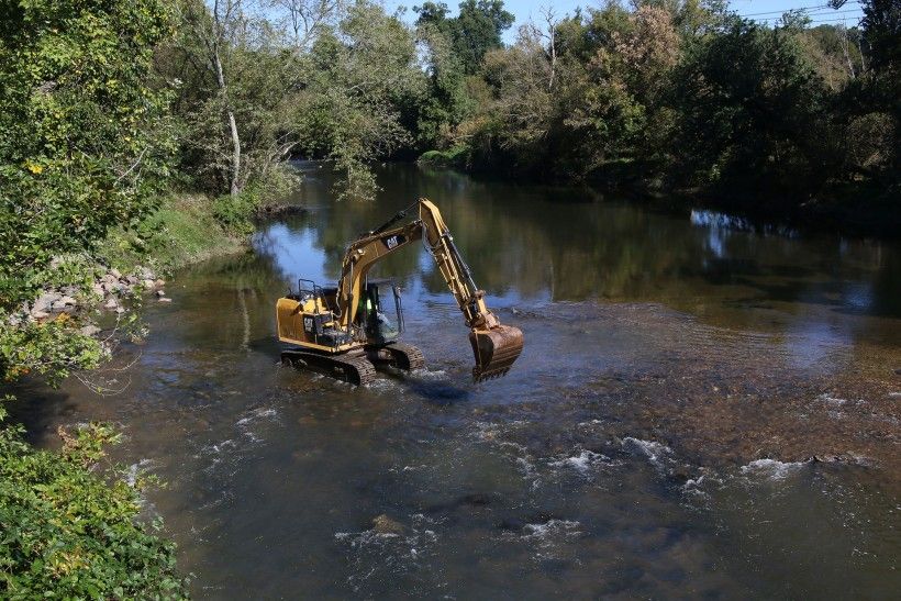 Construction vehicles removing the dam