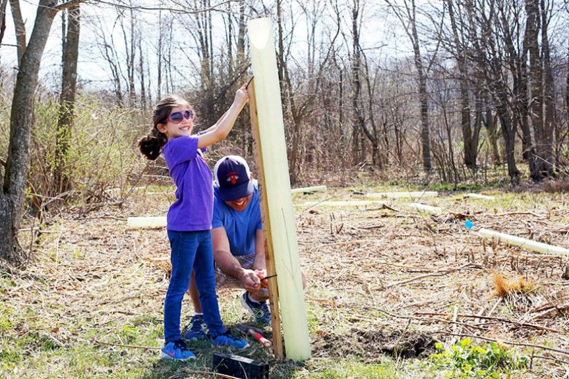 Smiling girl planting trees