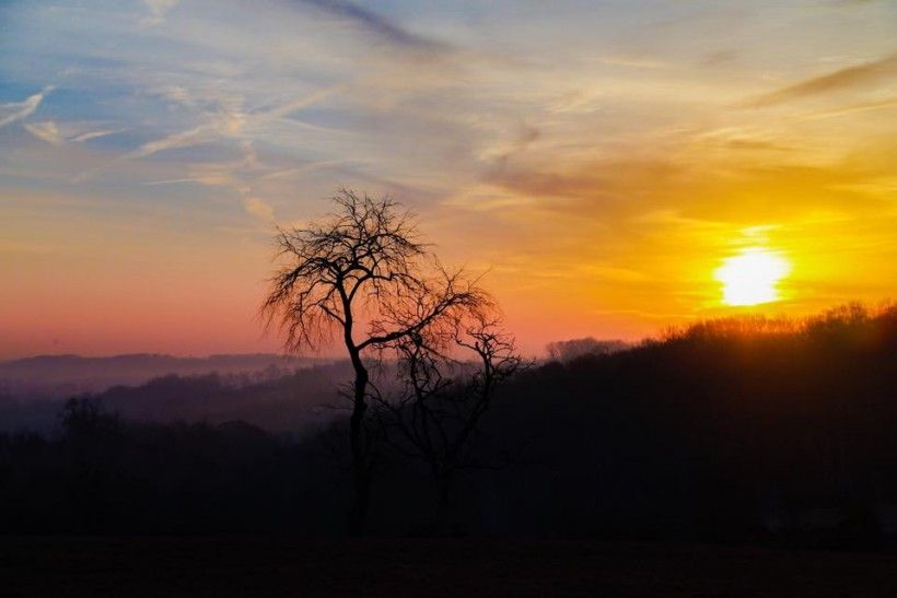 Sun setting in the distances along a beautiful landscape