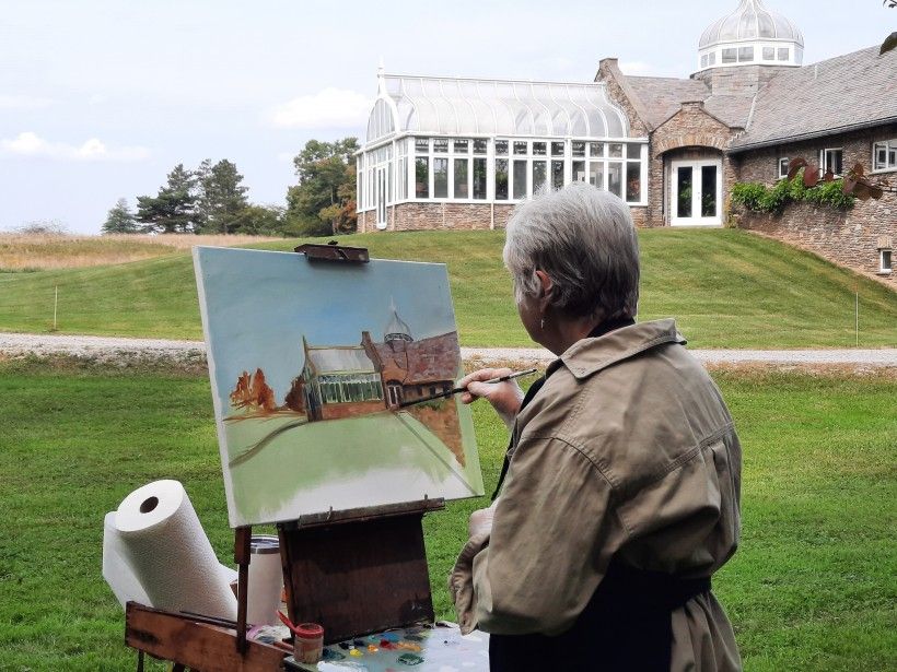 Artist Patricia Dickun painting Penguin Court's Conservatory