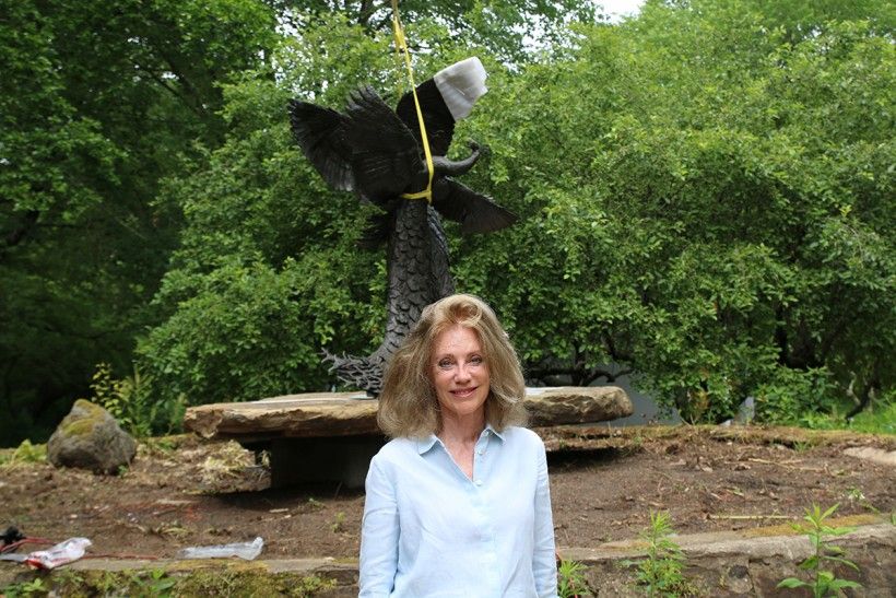 Rikki Morley Saunders standing in front of "Tipping Point" sculpture during its installation at the Brandywine