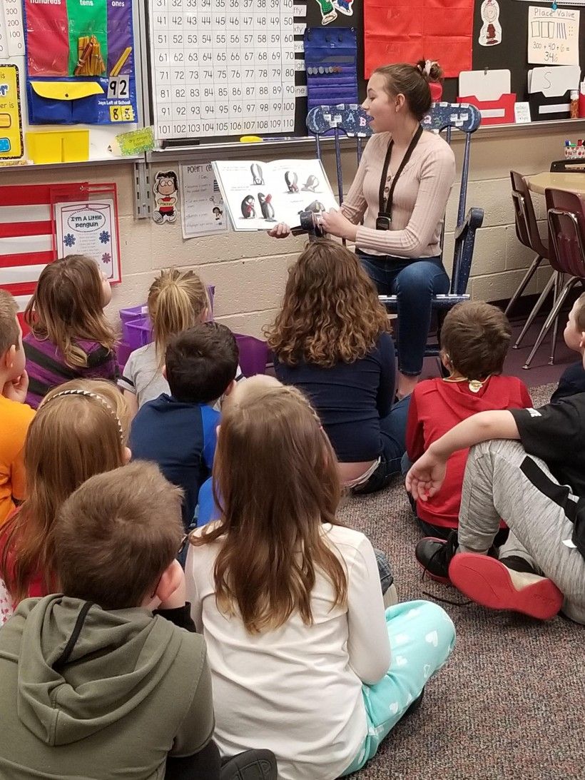 A middle school student reads “Little Penguin Gets the Hiccups” to first graders at Laurel Valley Elementary School.