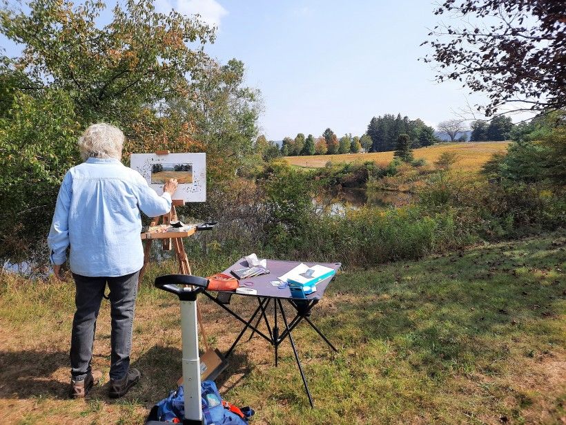 Artist Nan Houette painting at the pond at Penguin Court