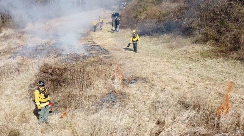 Burn crew making sure the fire goes out. Photo by Jim Moore. Burn crew making sure the fire goes out. Photo by Jim Moore.