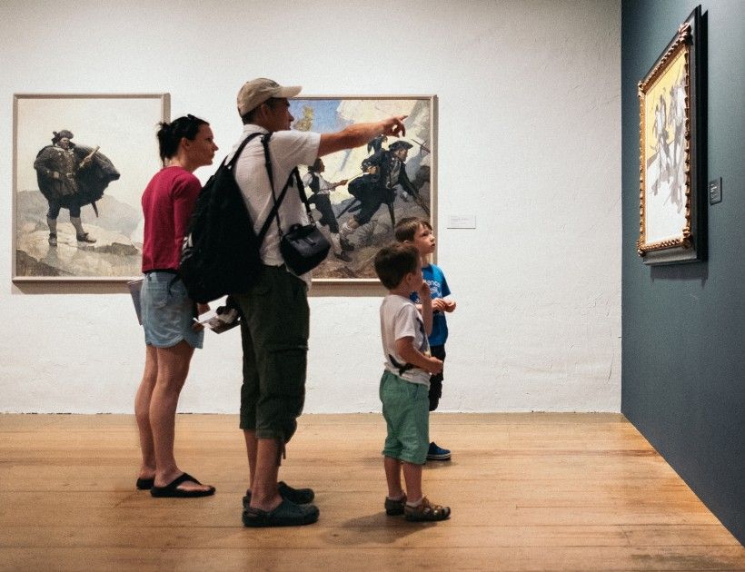 family of four looking at paintings in the N. C. Wyeth gallery